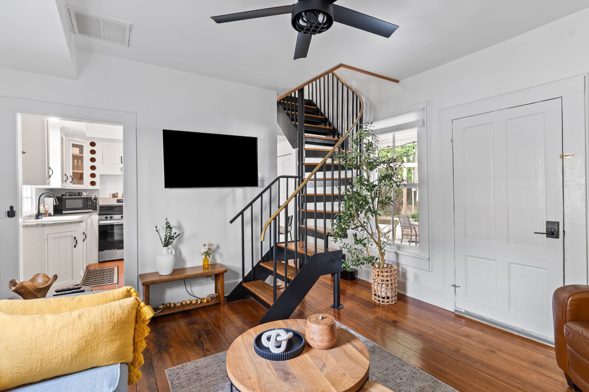 Spiral staircase and living area inside The Downtown Loft at Third & Oak Suites, downtown Wilmington NC