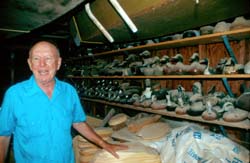Al Muller in his workshop with shelves of carved duck decoys